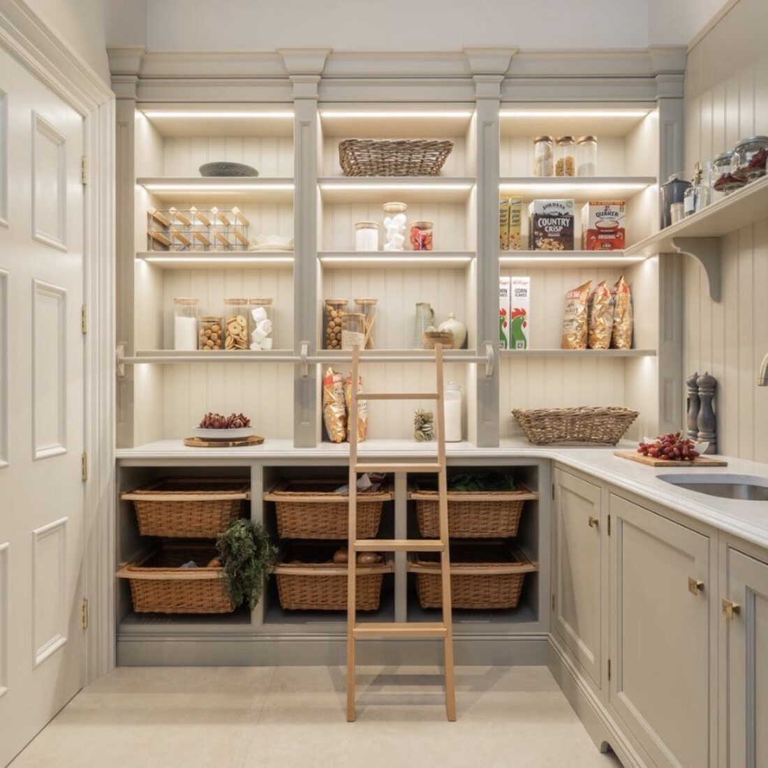 Pantry with woven baskets, open shelving, and prep sink
